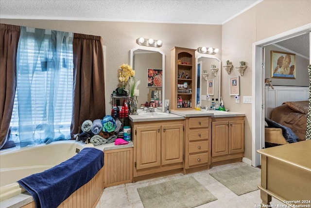 bathroom featuring a textured ceiling, tile patterned flooring, a bath, and a healthy amount of sunlight