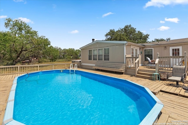 view of swimming pool featuring a deck