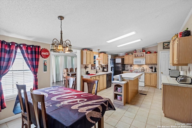 dining room with crown molding, a notable chandelier, sink, light tile patterned floors, and vaulted ceiling