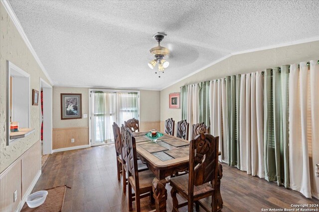 dining area with ceiling fan, dark hardwood / wood-style floors, a textured ceiling, and ornamental molding