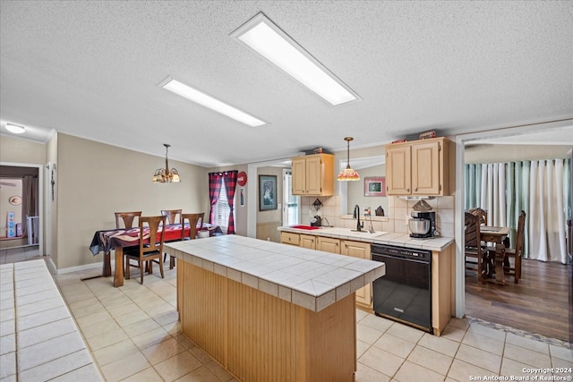 kitchen with black dishwasher, a kitchen island, tile countertops, and light hardwood / wood-style floors