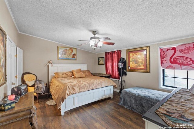 bedroom featuring ceiling fan, a textured ceiling, ornamental molding, and wood-type flooring