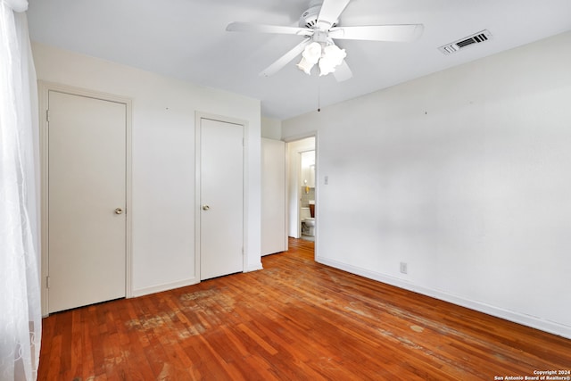 unfurnished bedroom with ceiling fan and wood-type flooring