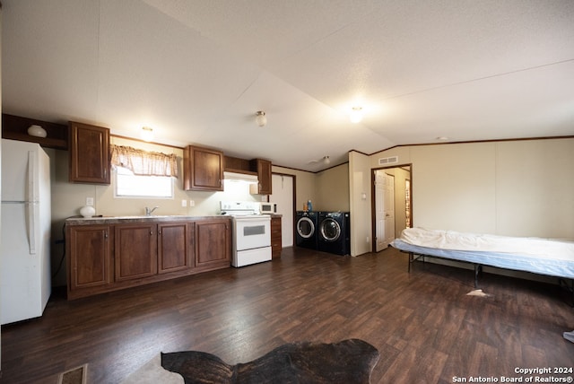 kitchen featuring independent washer and dryer, white appliances, dark wood-type flooring, and lofted ceiling