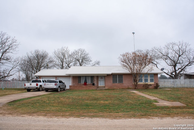 ranch-style home with a garage and a front yard