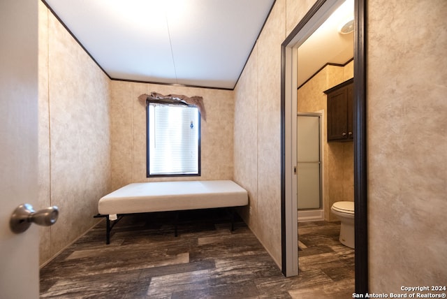 bathroom with toilet, hardwood / wood-style floors, and an enclosed shower