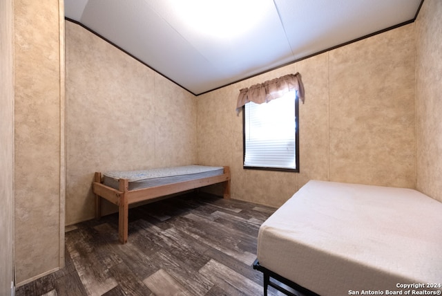 bedroom with lofted ceiling and hardwood / wood-style flooring