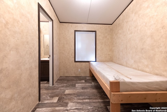 interior space with dark hardwood / wood-style floors, sink, and connected bathroom