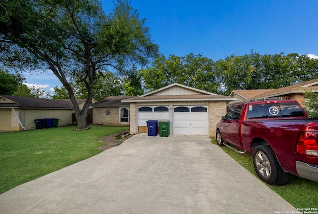 single story home featuring a garage and a front lawn