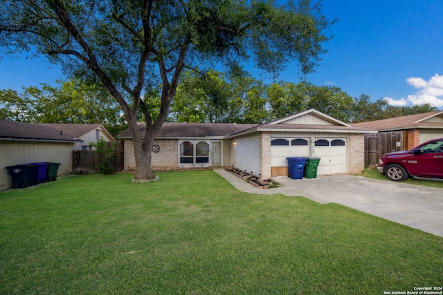 single story home with a garage and a front lawn