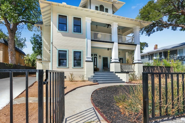 view of front of property with ceiling fan, covered porch, and a balcony