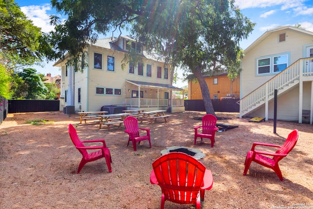 exterior space with an outdoor fire pit and cooling unit