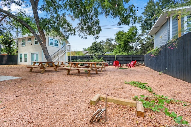 223 E Craig Pl, San Antonio, TX 78212 - fenced backyard with a fire pit and stairs