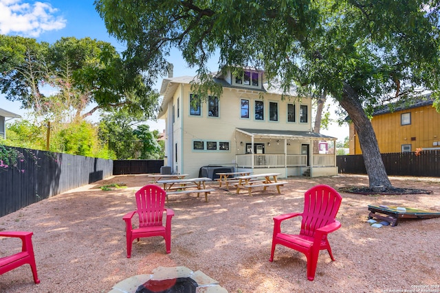 back of house featuring a fire pit and a patio