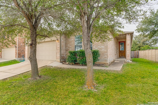 view of front of home with a front yard and a garage