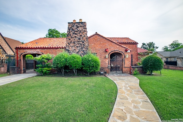 mediterranean / spanish-style home with a front yard