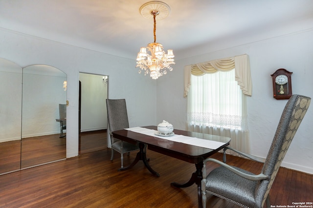 dining area featuring a notable chandelier and hardwood / wood-style flooring