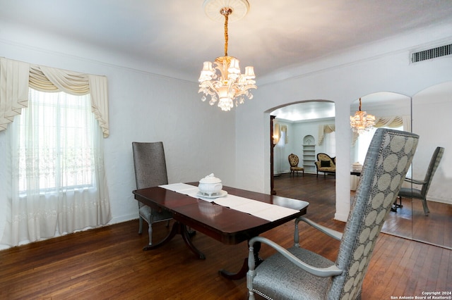 dining room with a notable chandelier and dark hardwood / wood-style floors