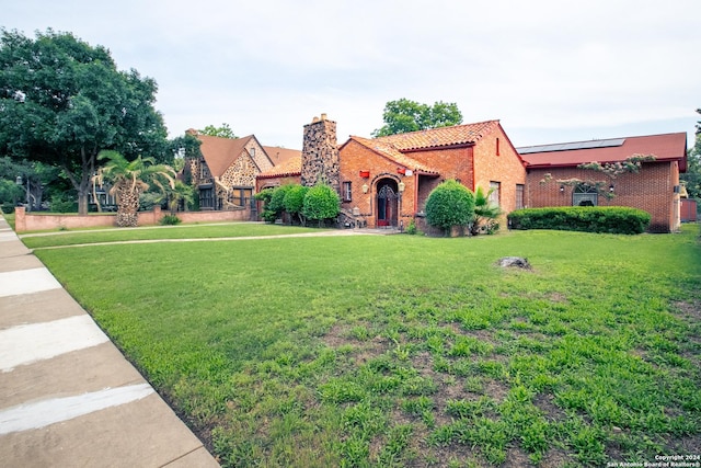 mediterranean / spanish-style home with a front yard