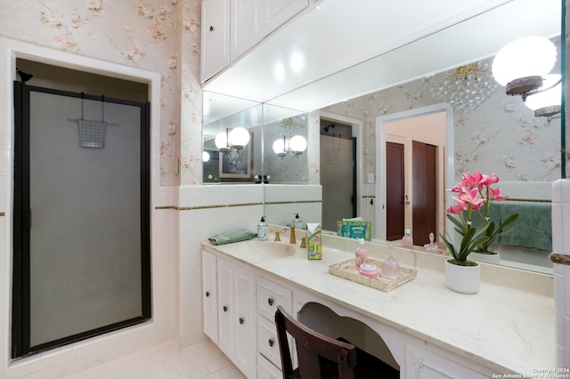 bathroom featuring tile patterned floors, vanity, and an enclosed shower