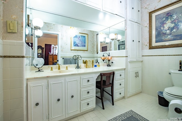 bathroom featuring vanity, tile walls, toilet, and tile patterned flooring