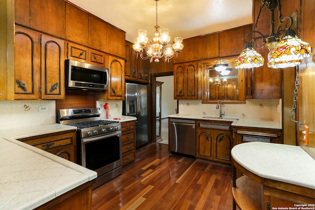 kitchen with a notable chandelier, tasteful backsplash, appliances with stainless steel finishes, and dark hardwood / wood-style floors