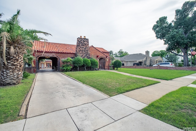 mediterranean / spanish-style house featuring a front yard