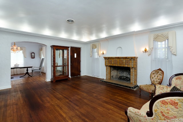 living room featuring a tiled fireplace and hardwood / wood-style flooring