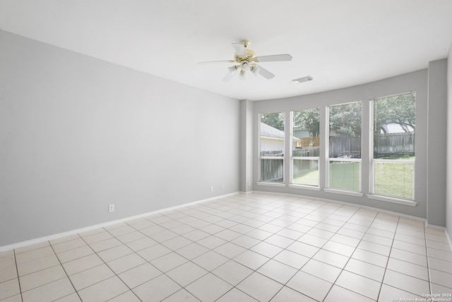 unfurnished room with light tile patterned flooring and ceiling fan