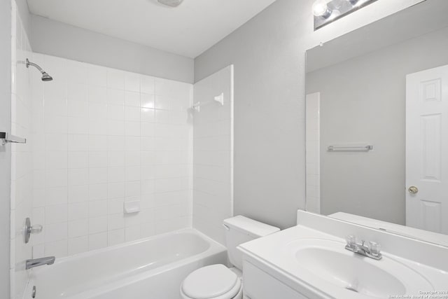 full bathroom featuring vanity, toilet, and tiled shower / bath combo