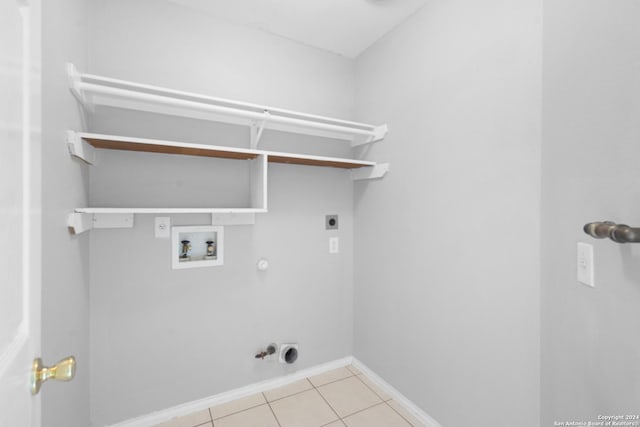 laundry area featuring gas dryer hookup, washer hookup, light tile patterned floors, and electric dryer hookup