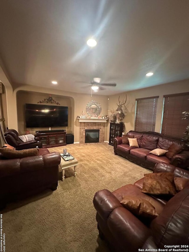 living room featuring a ceiling fan, carpet floors, a tile fireplace, and recessed lighting