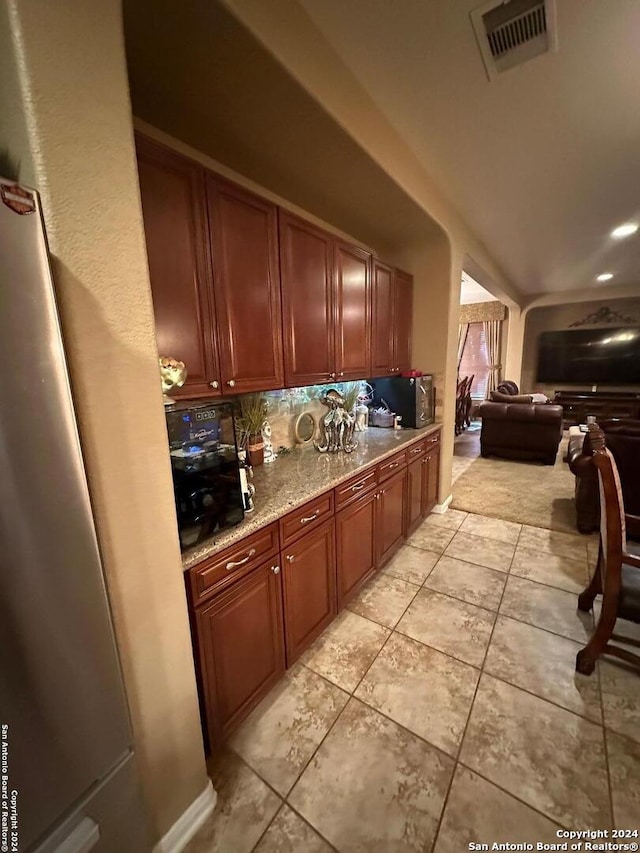 kitchen with light tile patterned floors and tasteful backsplash