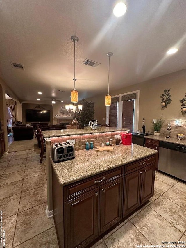 kitchen featuring a kitchen island, open floor plan, visible vents, and stainless steel dishwasher