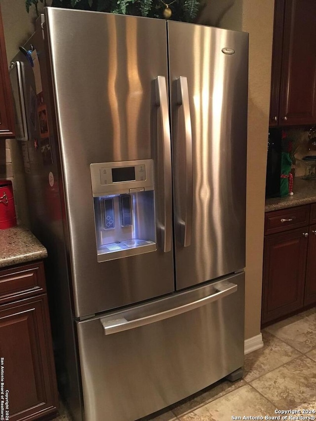kitchen with stainless steel fridge with ice dispenser and light countertops