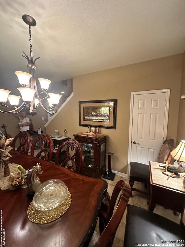 dining area featuring baseboards and a chandelier