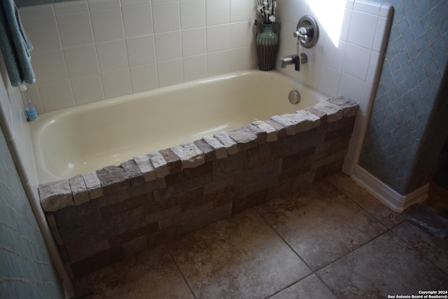full bath featuring tiled bath and tile patterned floors