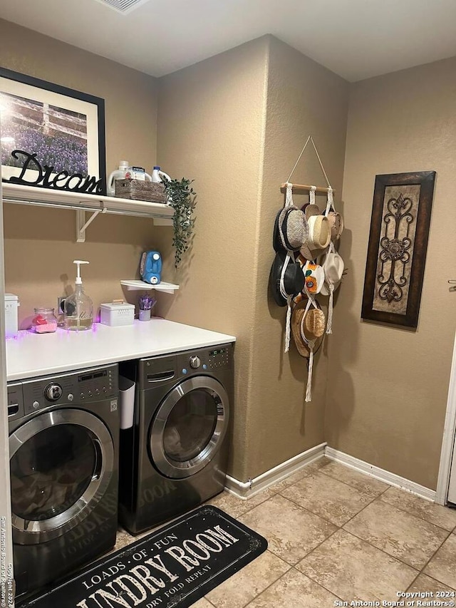 laundry area featuring baseboards, washing machine and dryer, laundry area, and tile patterned floors