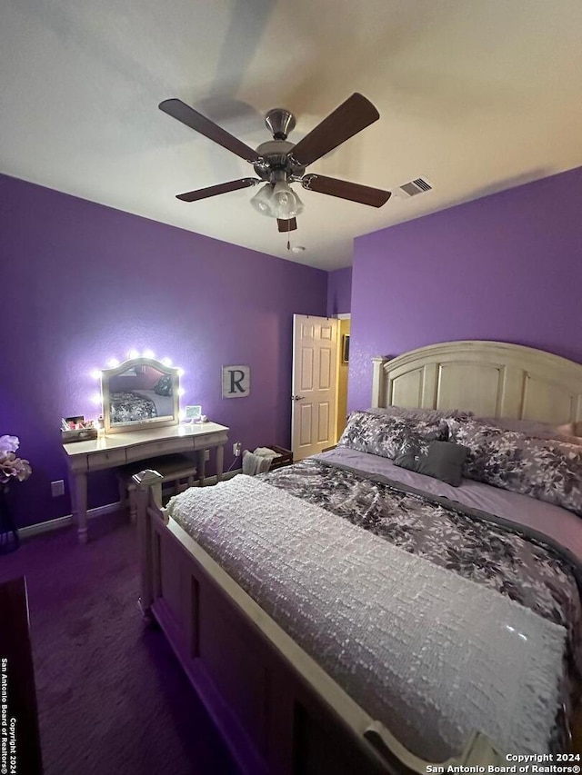 bedroom with ceiling fan, visible vents, and dark colored carpet