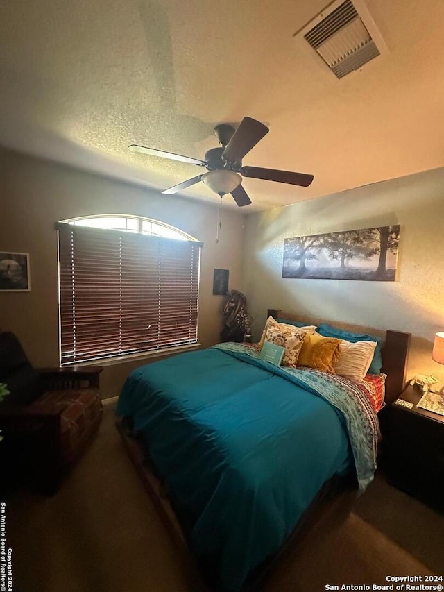 bedroom featuring carpet flooring, ceiling fan, and visible vents