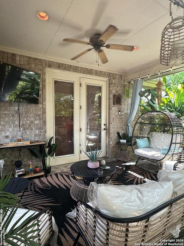 sunroom / solarium featuring ceiling fan