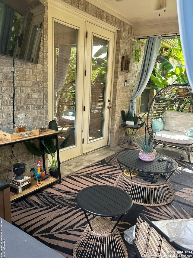 sunroom with french doors and brick wall