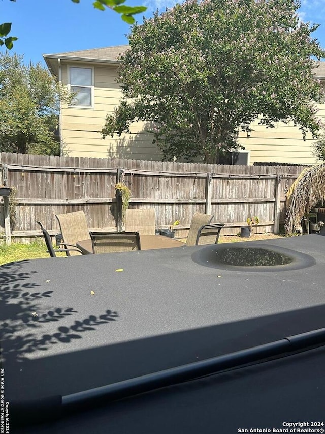 view of patio with outdoor dining area and fence
