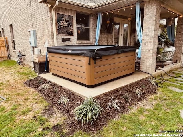 exterior space with fence and a hot tub