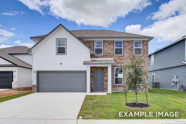 view of front of property with a front yard and a garage