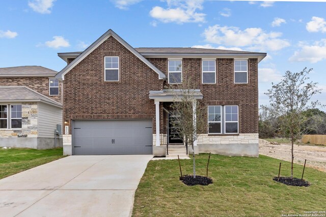 view of front of property with a front yard and a garage