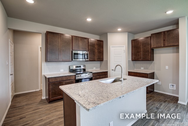 kitchen with appliances with stainless steel finishes, backsplash, sink, and dark wood-type flooring