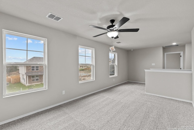 carpeted spare room with ceiling fan