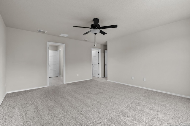 empty room with light carpet, a textured ceiling, and ceiling fan