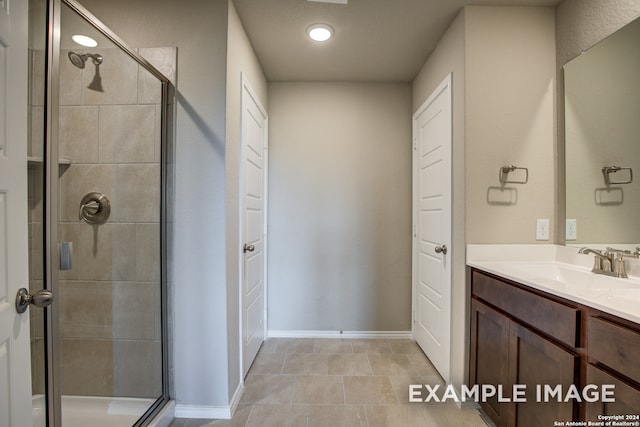 bathroom featuring tile patterned floors, walk in shower, and vanity